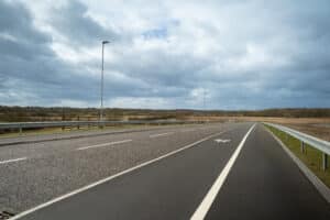 A new road with a pedestrian path along the side of it.