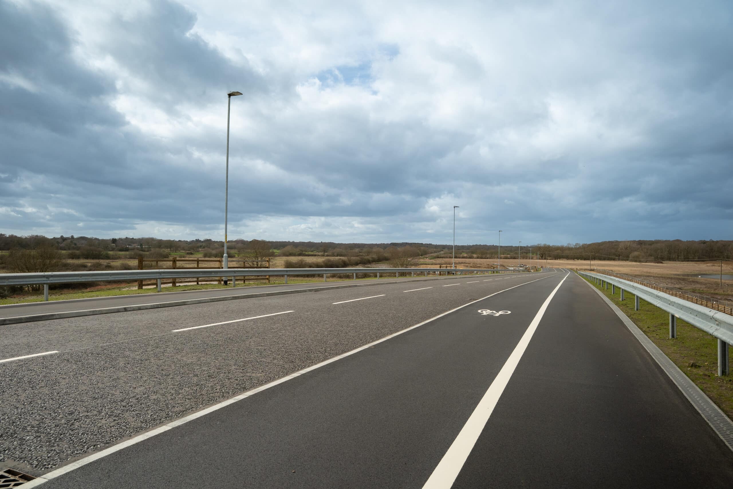 A new road with a pedestrian path along the side of it.